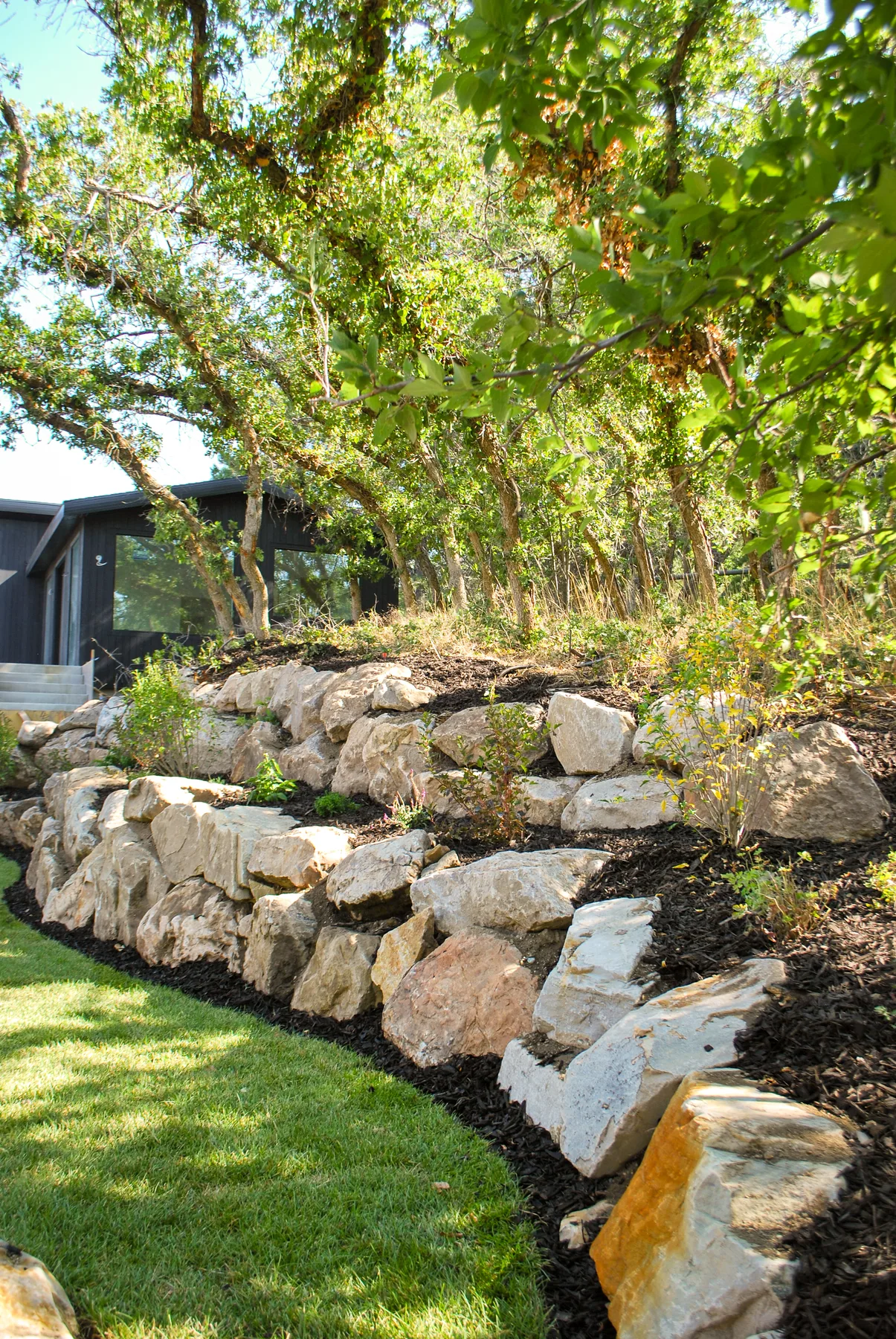 Boulder and block retaining wall installation