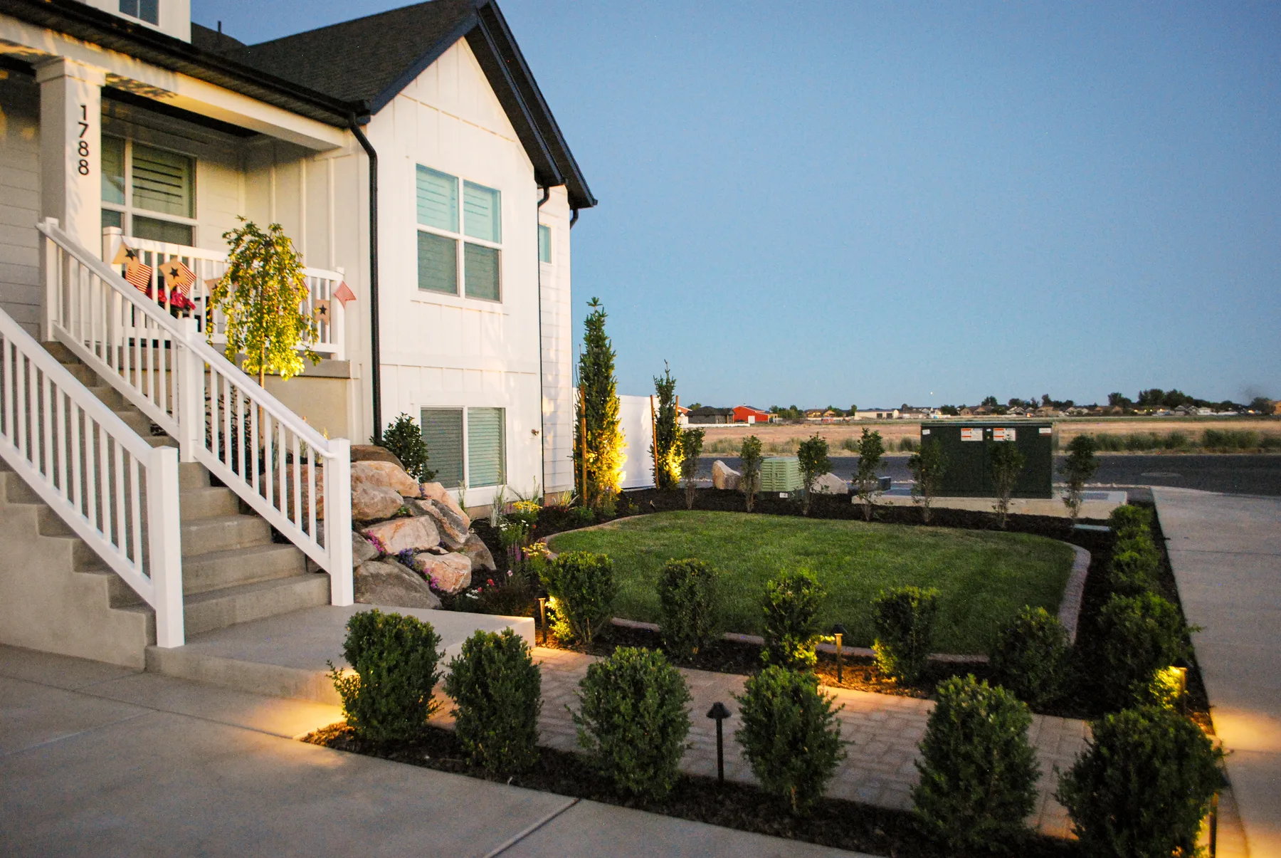 Low-voltage landscape lighting installation at dusk