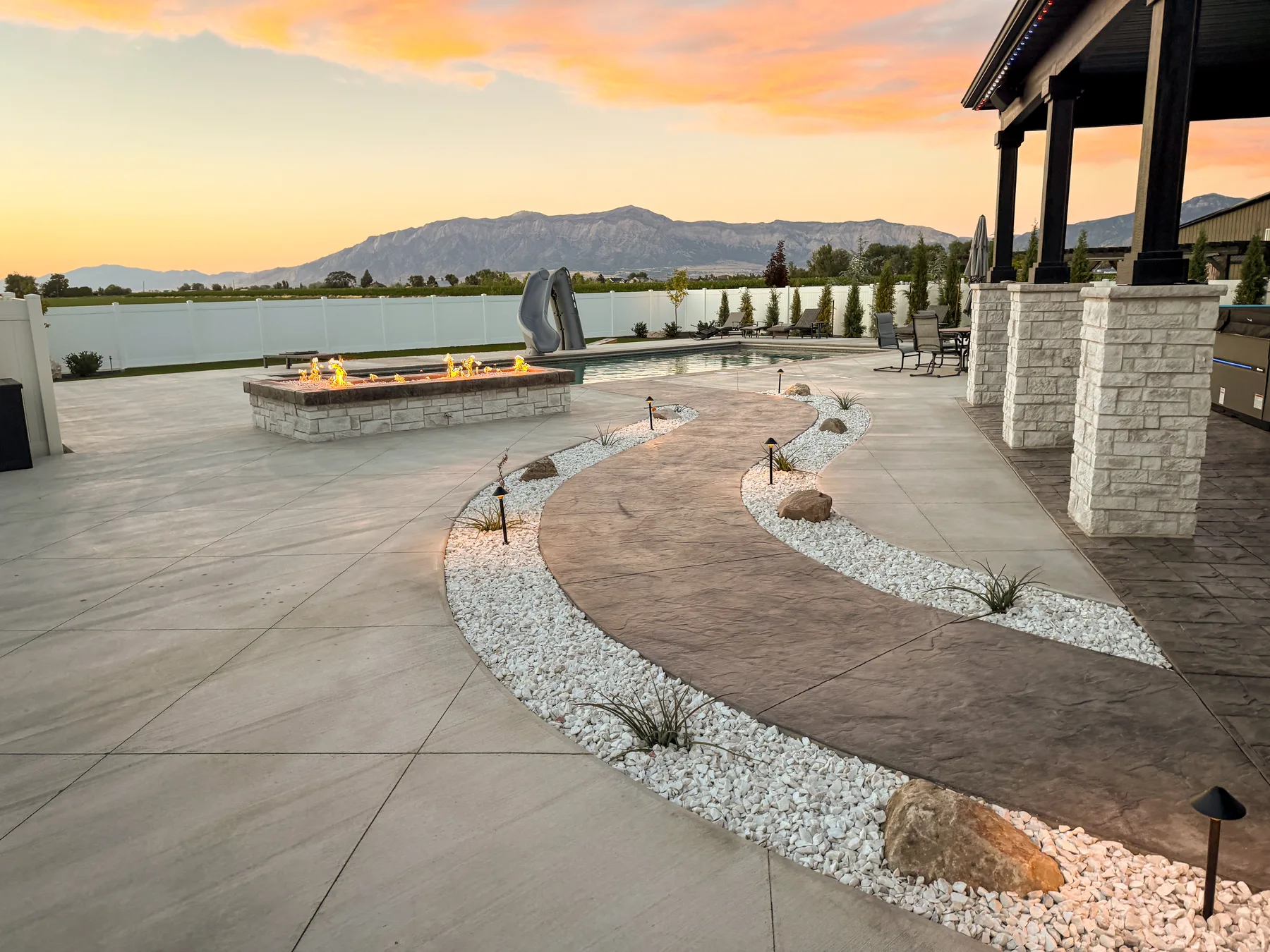 Low-voltage landscape lighting installation at dusk