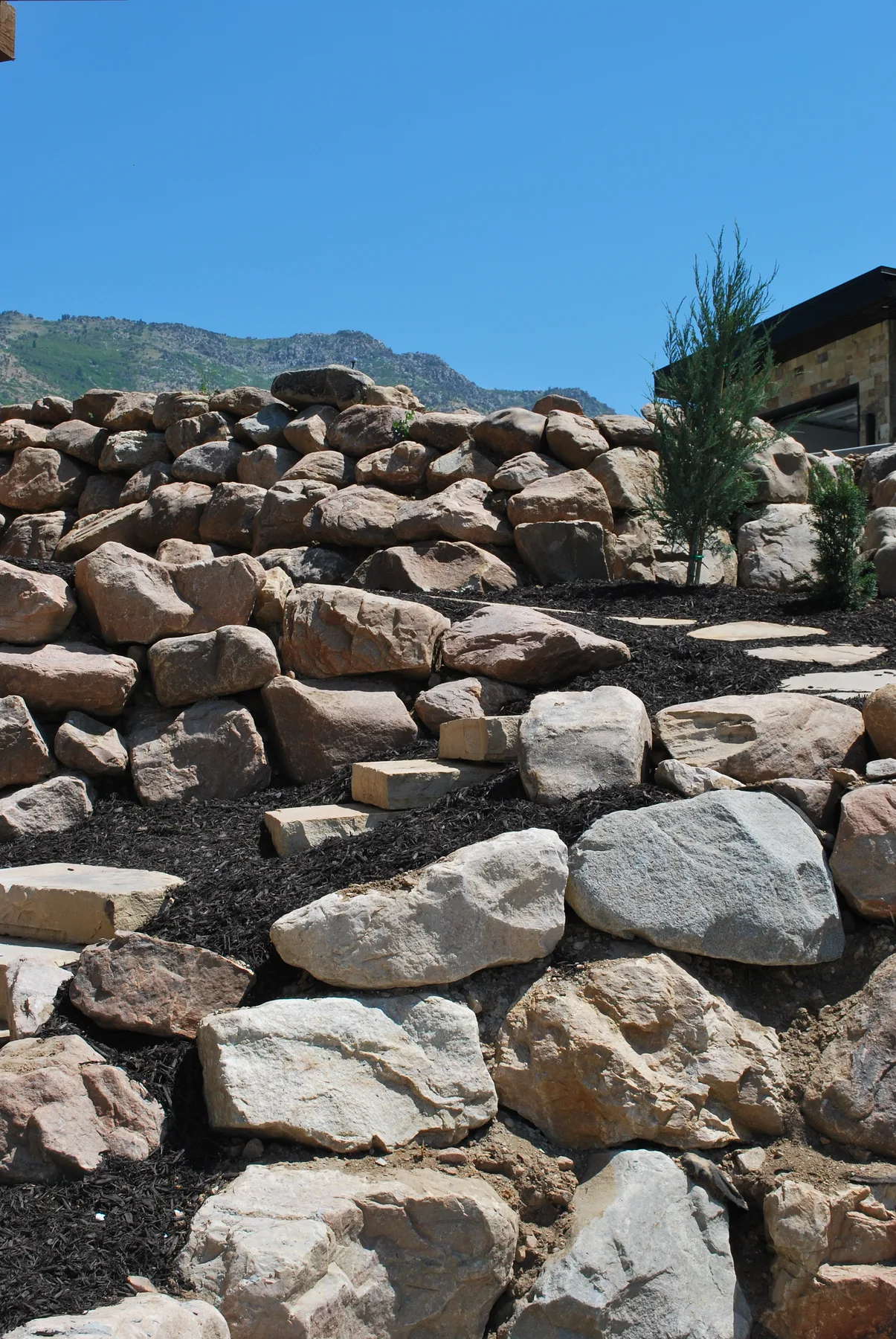 Boulder and block retaining wall installation