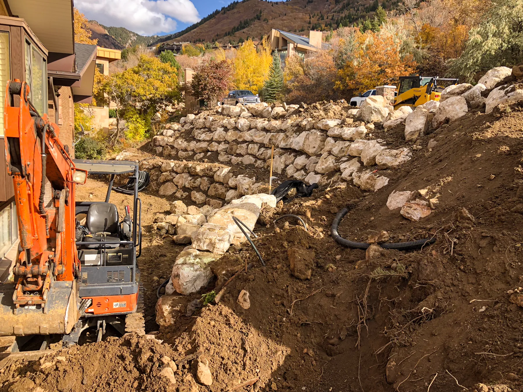 Boulder and block retaining wall installation