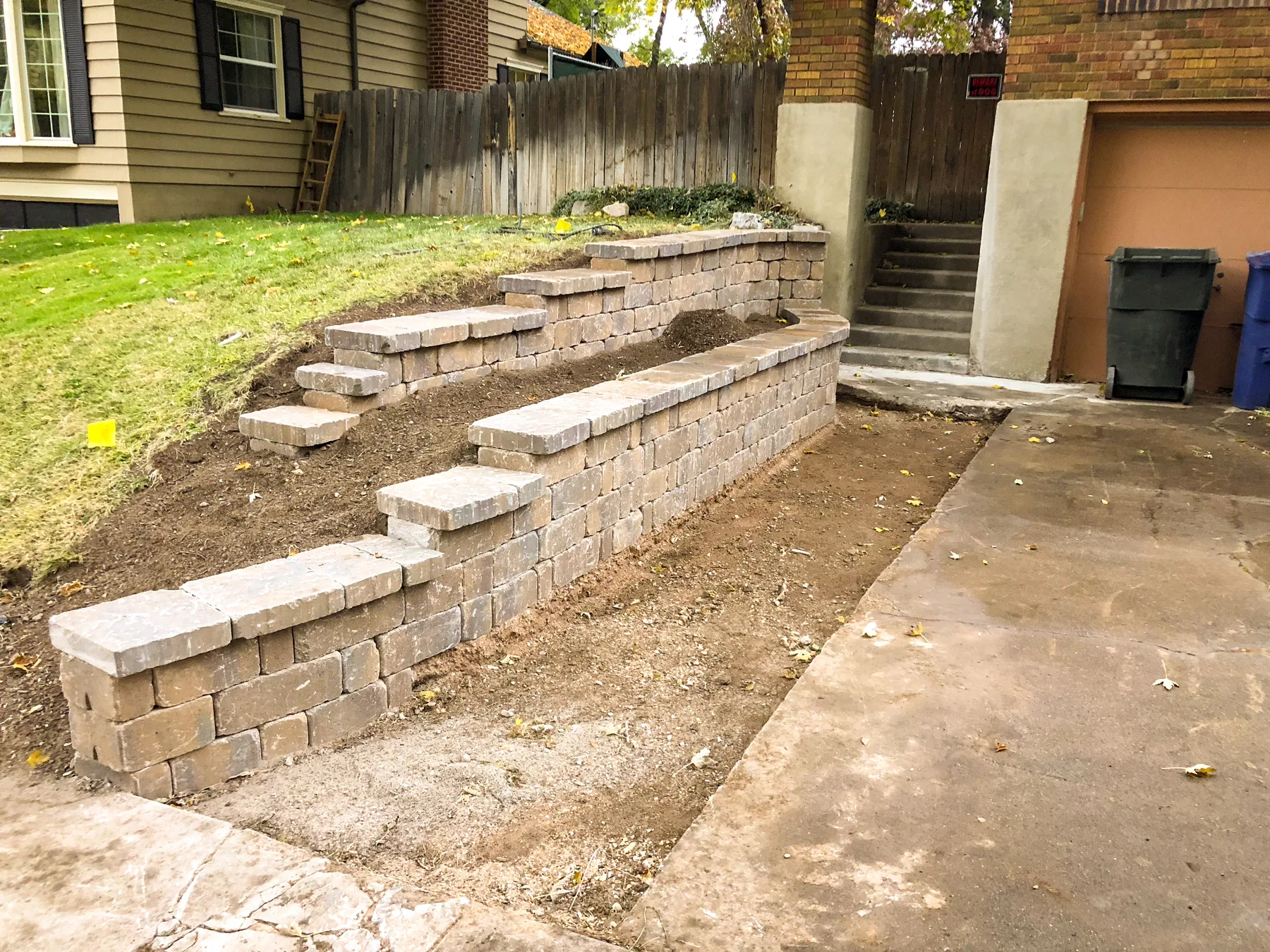 Boulder and block retaining wall installation