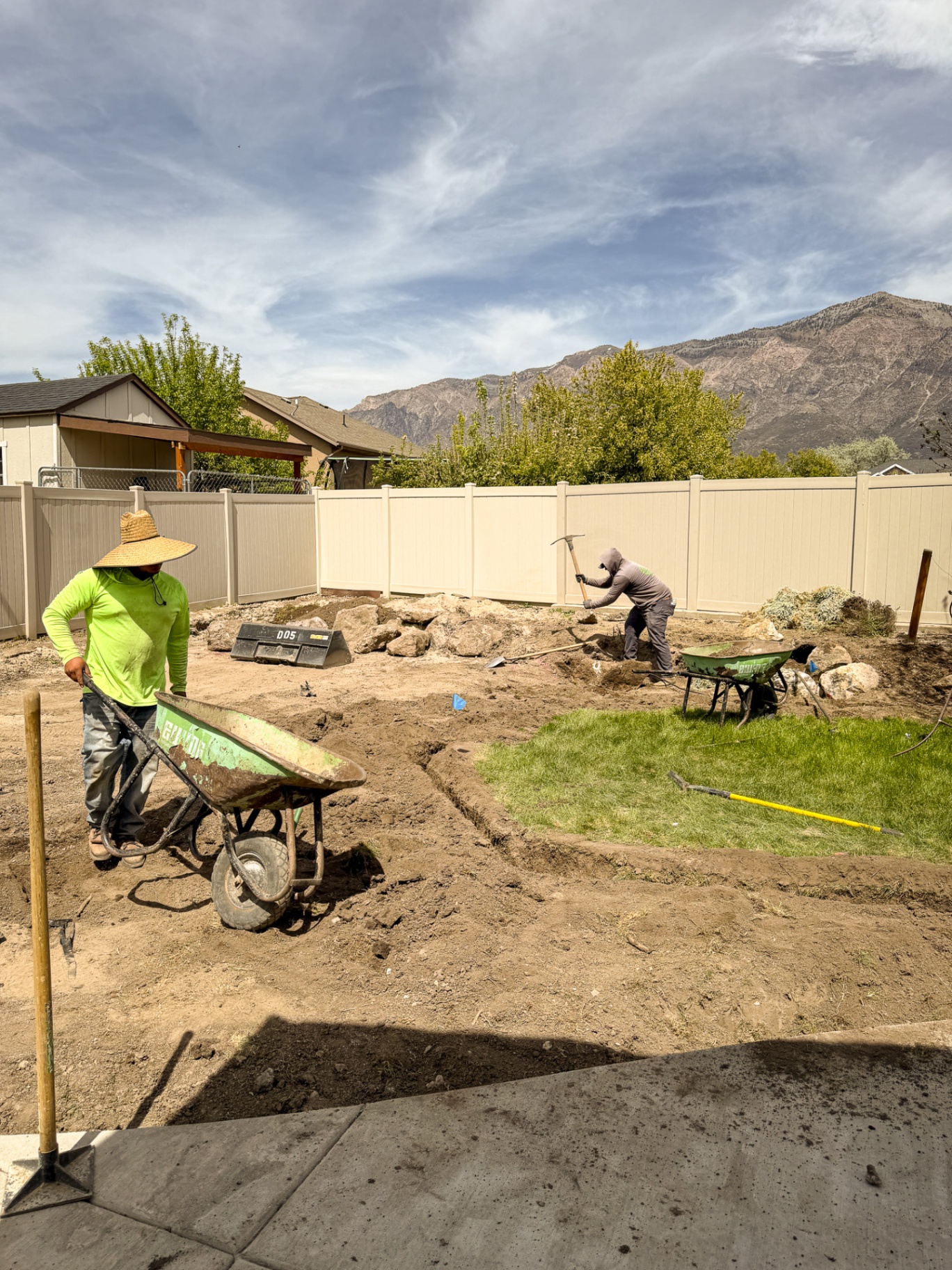 Backyard grading and site prep with mountain backdrop